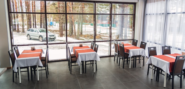 Dining tables and chairs in the restaurant. Light interior