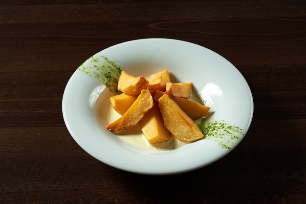 Dinner is served. Closeup of a plate full of sliced roasted potatoes