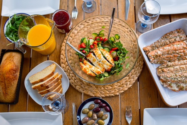 Dinner for a large company on the terrace top view Healthy food on the table Salad with cheese