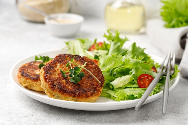 dinner lunch concept quinoacutlets served with lettuce tomatoes microgreens diet food close up