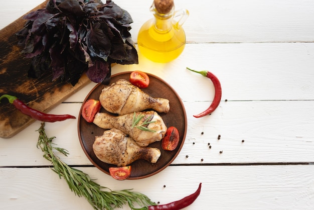 Dinner for the whole family, tasty and juicy chicken legs fried in the oven, the aroma of fresh herbs, basil and rosemary, meat marinade