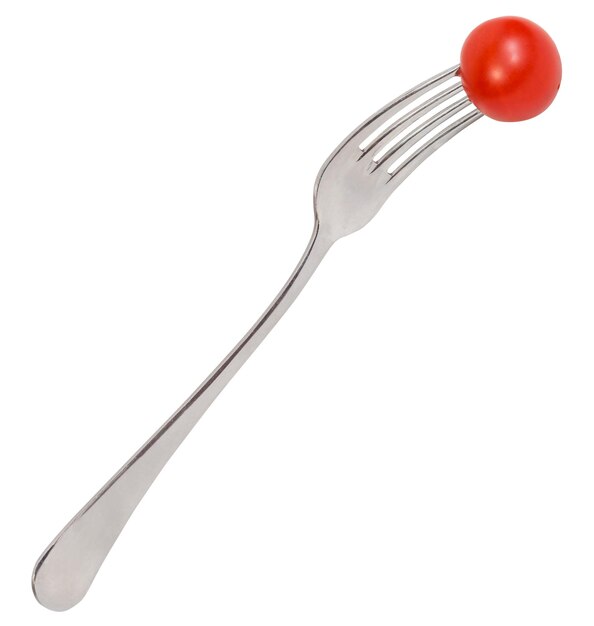 Photo dinning fork with one fresh red cherry tomato