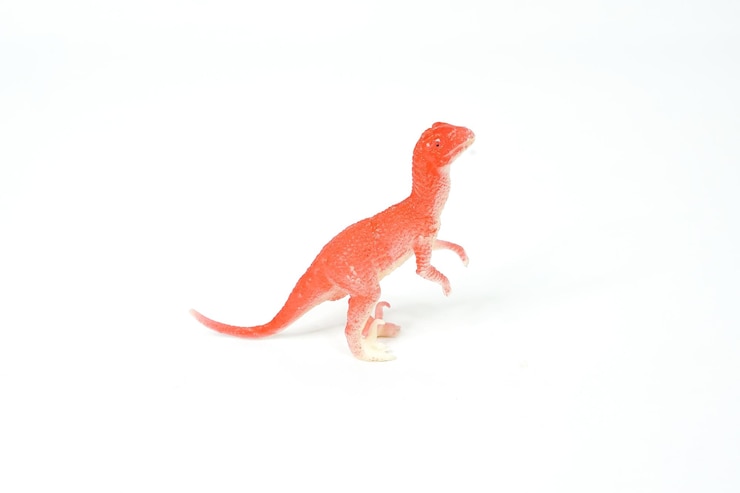 Photo 恐竜。白で隔離されるプラスチック ゴムのおもちゃ。
