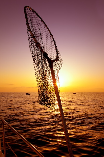 Photo dip net in boat fishing on sunrise saltwater