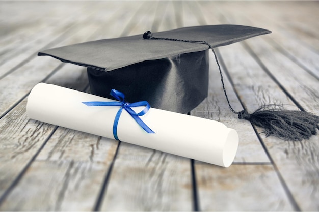 Diploma with blue ribbon on table