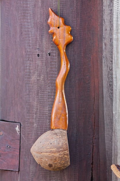 Dipper made from coconut shell on wood background