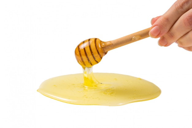 Dipper with honey in woman hand.