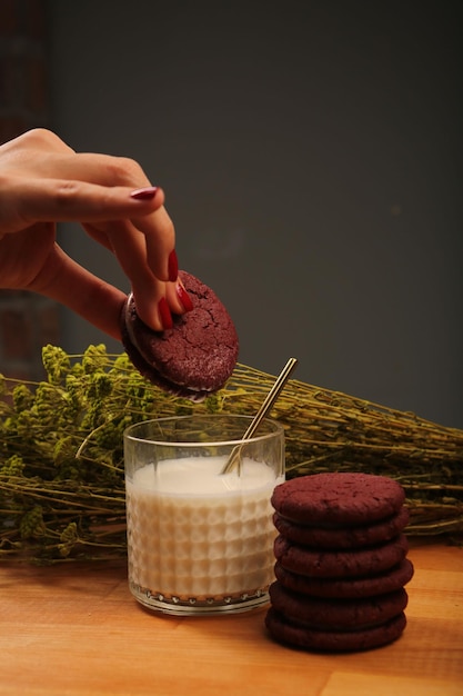 Dipping delicious cookies in a glass of milk