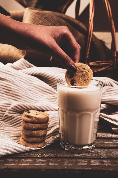 Dipping delicious cookies in a glass of milk