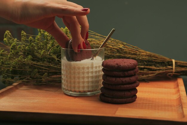 Dipping delicious cookies in a glass of milk