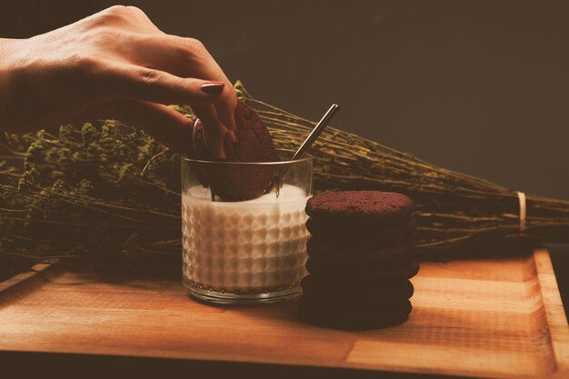 Dipping delicious cookies in a glass of milk