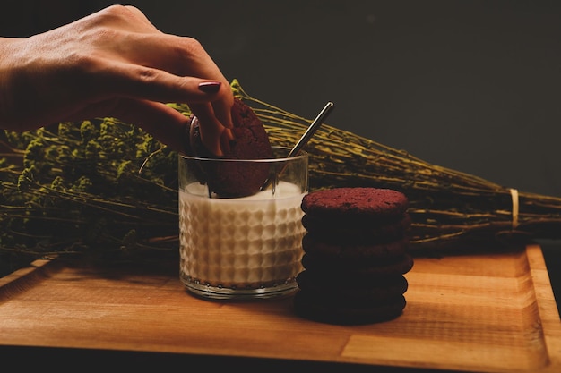 Dipping delicious cookies in a glass of milk