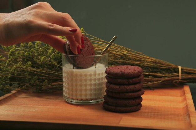 Dipping delicious cookies in a glass of milk