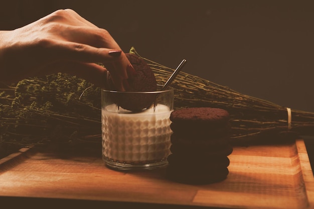 Dipping delicious cookies in a glass of milk