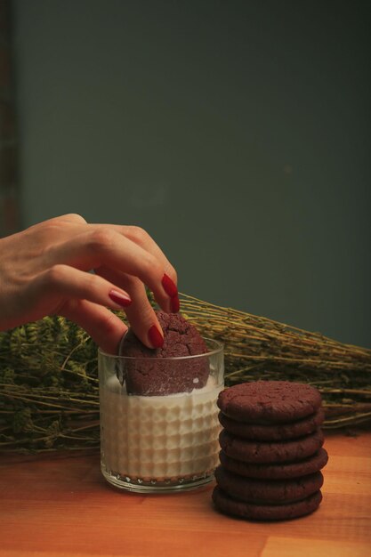 Dipping delicious cookies in a glass of milk