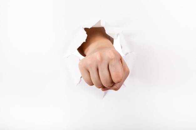 Direct view of the fist punches a paper