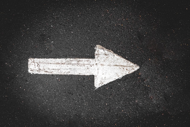 Photo direction arrow on asphalt right sign marking of traffic in the park