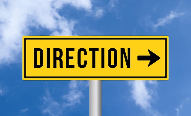 Direction road sign on blue sky background