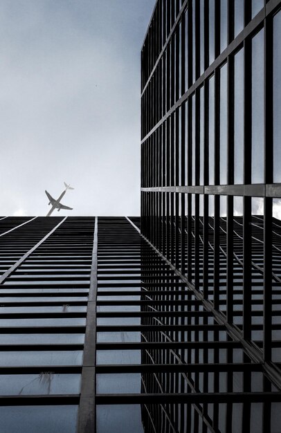 Photo directly below shot of airplane flying over modern building