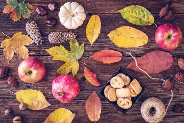 Photo directly above shot of autumn leaves with food on table