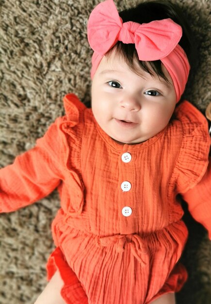 Photo directly above shot of baby girl lying on bed