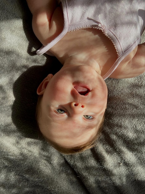 Photo directly above shot of baby lying on bed