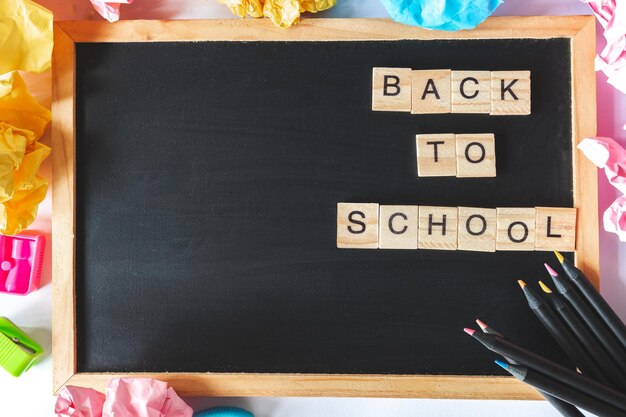 Photo directly above shot of back to school text on blackboard