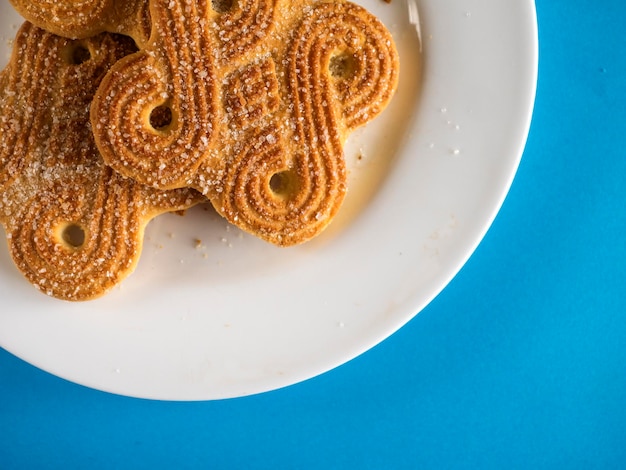 Directly above shot of biscuits in plate on blue table