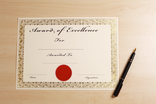 Directly above shot of blank certificate and fountain pen on wooden table