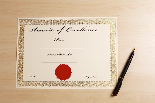 Photo directly above shot of blank certificate and fountain pen on wooden table