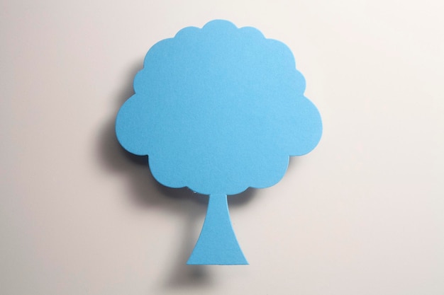 Directly above shot of blue tree shaped decoration on white background