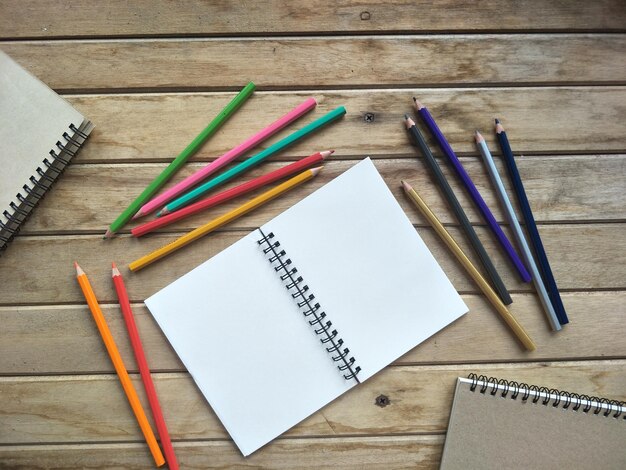 Photo directly above shot of book and colored pencils on table