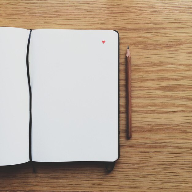 Photo directly above shot of book and pencil on table