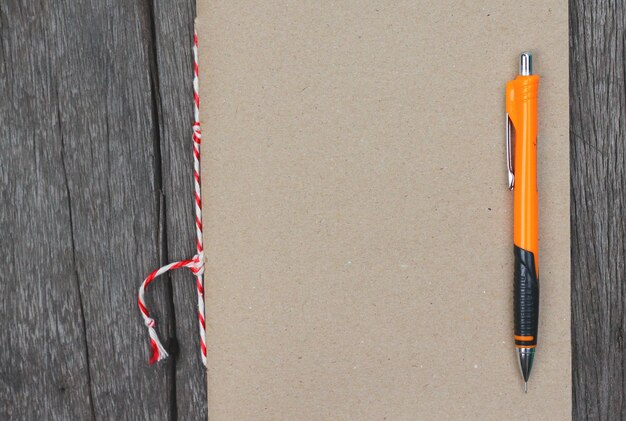 Photo directly above shot of book with pen on wooden table