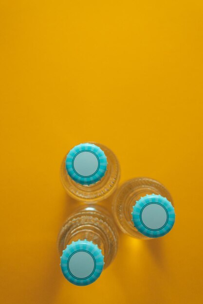 Directly above shot of bottles over orange background