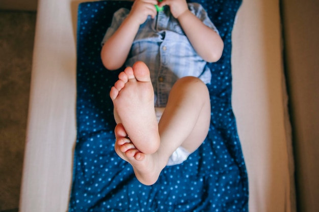 Photo directly above shot of boy lying on bed at home