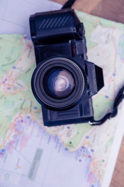 Directly above shot of camera and map on table