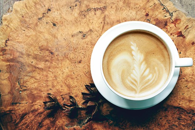 Photo directly above shot of cappuccino on tree stump