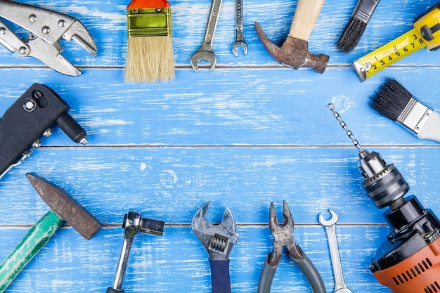 Directly above shot of carpentry tools on blue table