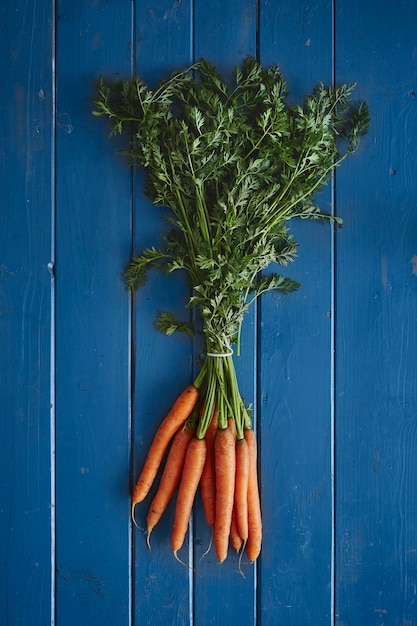 Directly above shot of carrots on blue table