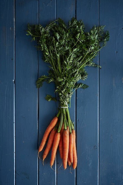 Directly above shot of carrots on blue table