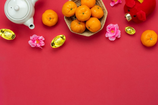 Directly above shot chinese new year decoration and fruits on pink background