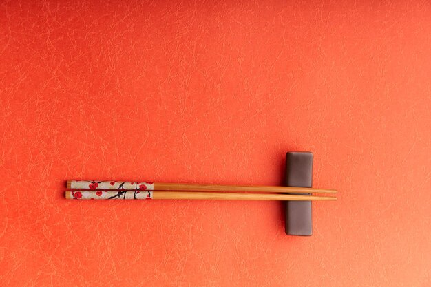 Photo directly above shot of chopsticks on red table