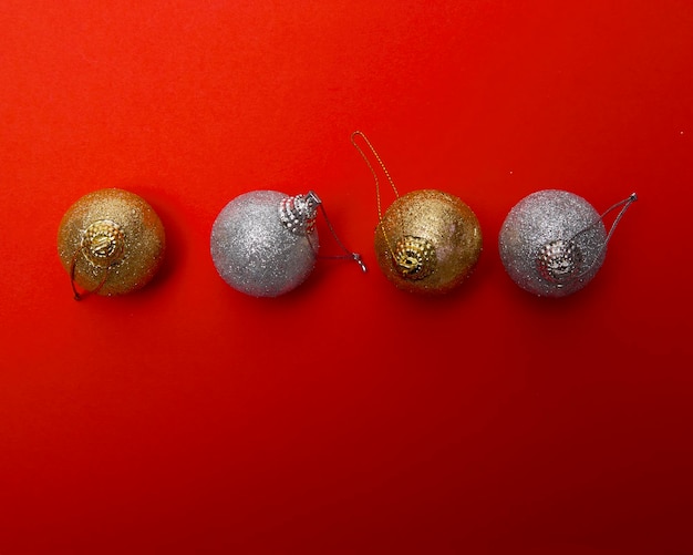 Directly above shot of christmas ornaments on red background