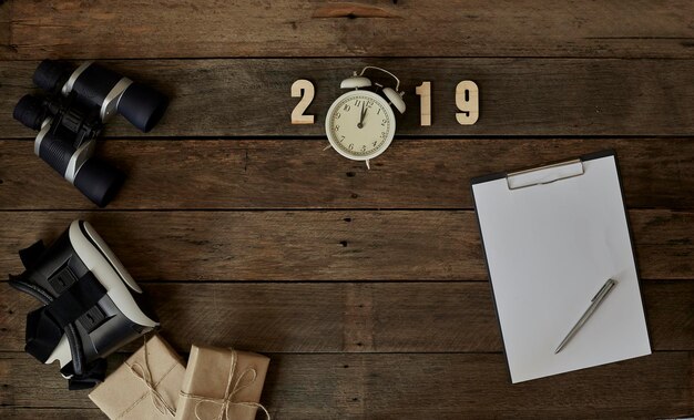 Directly above shot of clock and notepad on table