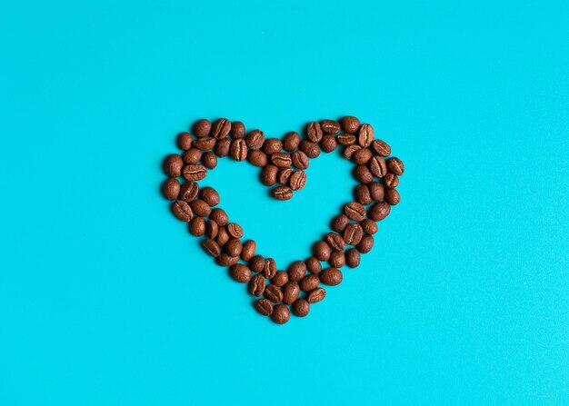 Directly above shot of coffee beans over blue background