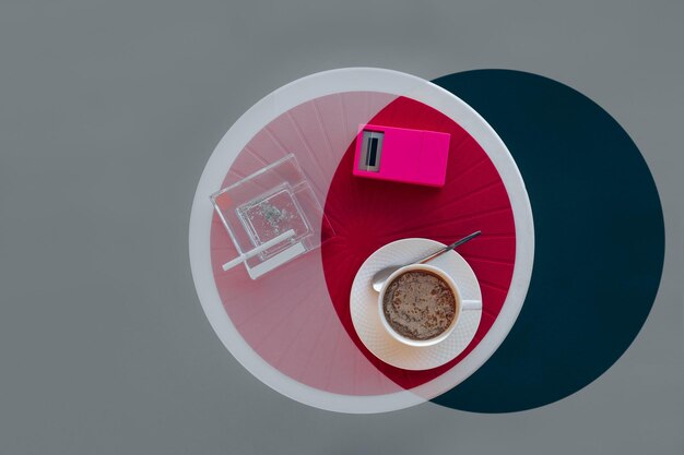 Photo directly above shot of coffee cup against pink and grey background