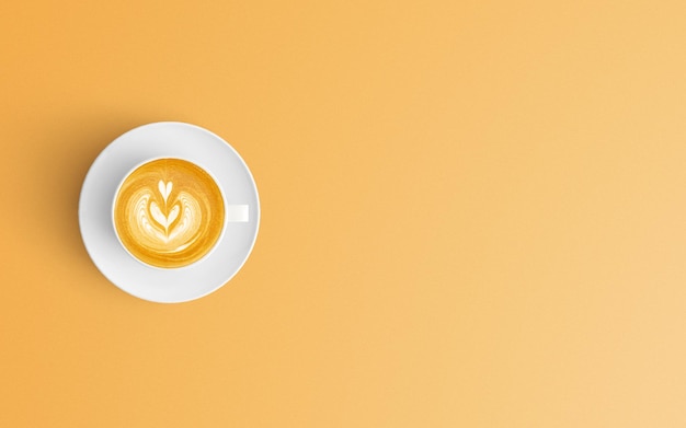 オレンジ色の背景のコーヒーカップの直接上のショット