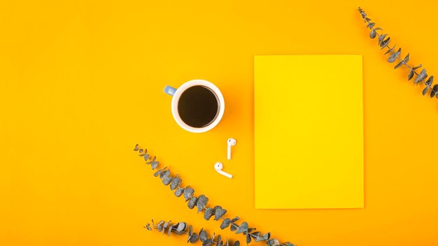 Directly above shot of coffee cup on table against yellow background