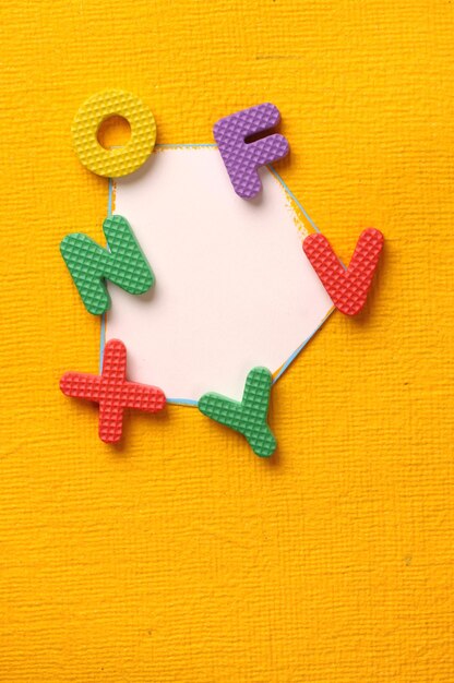 Photo directly above shot of colorful alphabets on blank paper at table